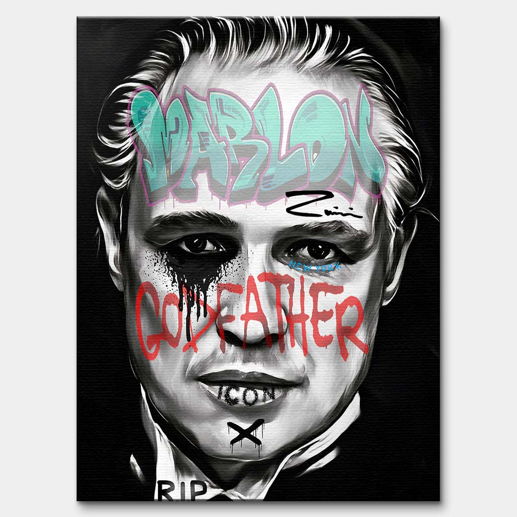 Czarno-biały obraz na płótnie Marlon Brando z filmu Ojciec Chrzestny. Wydruk galeryjny pop art z niebieskim napisem Marlon i czerwonym tekstem Godfather.
