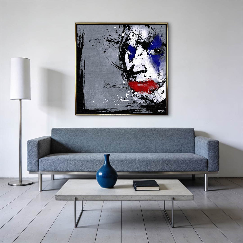 Obraz na płótnie z twarzą Jokera w stylu splash art. Nowoczesny wydruk galeryjny w kolorach szarym, niebieskim i czerwonym. Kunst pop-art.