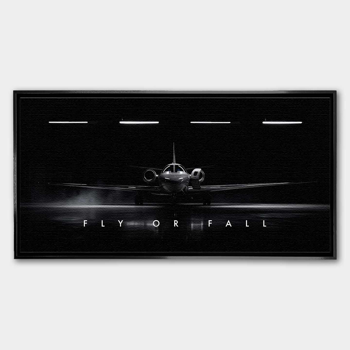 Obraz motywacyjny na płótnie Fly or Fall przedstawiający prywatny odrzutowiec w ciemnym hangarze z napisem „Fly or Fall”, symbolizujący luksus, odwagę i determinację.