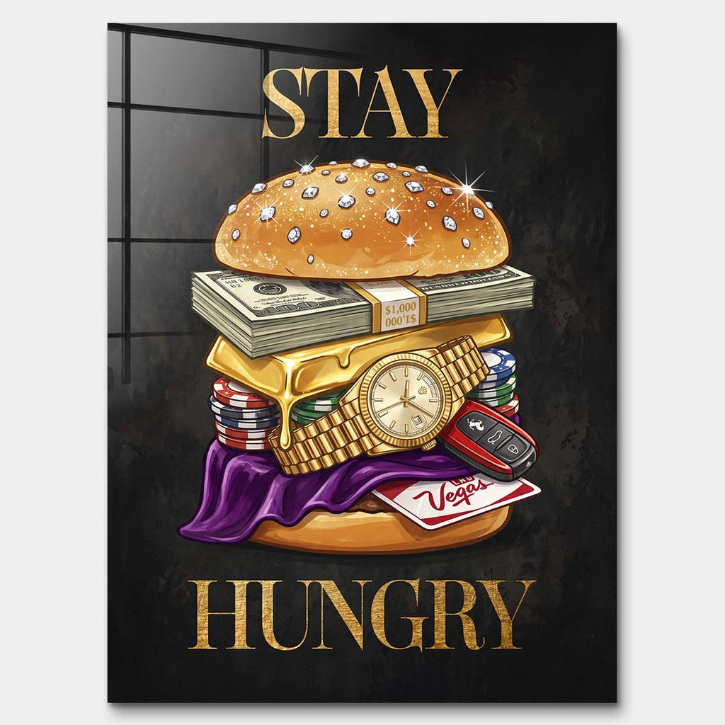 Nowoczesny obraz na szkle akrylowym przedstawiający burgera z banknotów, złota i zegarka oraz złoty napis STAY HUNGRY na czarnym tle. Wydruk galeryjny Huephant.